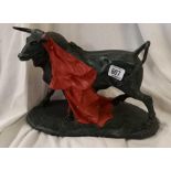 FIGURE OF BULL WITH RED CAPE 12'' ACROSS AT BASE