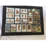 A COLLECTION OF 20 TEDDY BEAR POSTCARDS, MANY CIRCA 1910, CONTAINED IN A CARVED WOOD FRAME. SOME