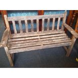 A WEATHERED TEAK GARDEN BENCH 4FT WIDE