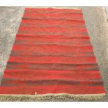 RED GROUND EASTERN CARPET WITH TASSELLED ENDS 6FT 3'' X 5FT 2''