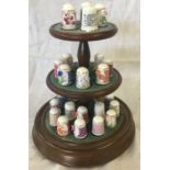 QTY OF PORCELAIN THIMBLE'S ON 3 TIER WOODEN DISPLAY CASE WITH GLASS DOME