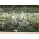 SHELF OF VARIOUS DECANTERS, VASES,GOBLETS, SUNDAE DISHES ETC