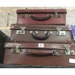 STAGGERED SET OF BROWN SUITCASES