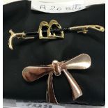 2 BROOCHES, 1 RIDING CROP, 1 BOW