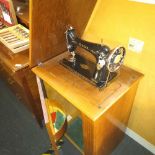 1950'S SINGER TREADLE SEWING MACHINE IN TEAK CABINET