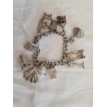 SILVER CHARM BRACELET WITH MULTIPLE LARGE CHARMS. WEIGHT 3.5ozs