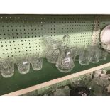 SHELF OF WHISKY TUMBLES & PAIR OF GLASS WATER JUGS