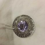 A SCOTTISH SILVER CELTIC BROOCH WITH LARGE AMETHYST COLOURED STONE - EDINBURGH