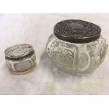 TWO SILVER TOP JARS WITH GLASS BODIES