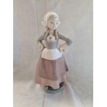 LLADRO FIGURE OF A DUTCH GIRL WITH ARMS AKIMBO & A NAO FIGURE BY LLADRO OF A SWAN FLAPPING WINGS