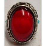 LARGE SILVER COLOURED RING MARKED 90 WITH LARGE RED STONE