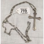 A SILVER CROSS ON A SILVER NECK CHAIN