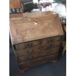 A GEORGIAN OAK BUREAU WITH BRASS DROP HANDLES A/F