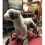 A CHILD'S VINTAGE PUSH ALONG DOG ON 4 WHEELS