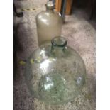 A LARGE CARBOY & A DEMIJOHN WITH CORK BUNG & SPOUT WHICH IS CRACKED & LOOSE