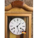 HERMLE KEY WOUND WALL CLOCK WITH HALF HOUR STRIKE IN GLASS & BEECH WOOD CASE