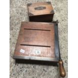OAK METAL DECORATED BOX WITH GUN CLEANING OILS & PATCHES & A VINTAGE PAPER GUILLOTINE