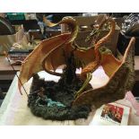 RESIN FIGURE OF A DRAGON ATTACKING A COUPLE