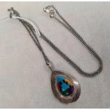 A SILVER MOUNTED PENDANT ON FINE SILVER NECK CHAIN
