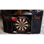 A WINMAU LAKESIDE WORLD CHAMPIONSHIP DARTBOARD IN CABINET, NO DARTS