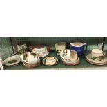 SHELF OF TORQUAY POTTERY MOTO WARE INCL; TEA POT, CUPS, SAUCERS, PLATES ETC