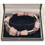 A PINK QUARTZ, BEAD AND WHITE METAL BRACELET IN THE ART DECO STYLE