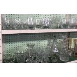 SHELF OF CUT GLASS & OTHER GLASSWARE WITH WHISKY TUMBLERS, WINE GLASSES, DECANTERS ETC