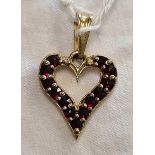 A 13 STONE GARNET HEART SHAPED PENDANT SET IN 9ct