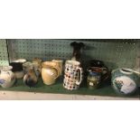 SHELF WITH WATER JUGS, PLATES ETC