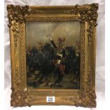 A GILT FRAMED OIL PAINTING OF CHARGING CAVALRY