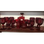 SHELF OF RED GLASS GOBLETS ETC