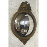 GILT FRAMED CONVEX MIRROR SURMOUNTED BY A GILT WOODEN EAGLE