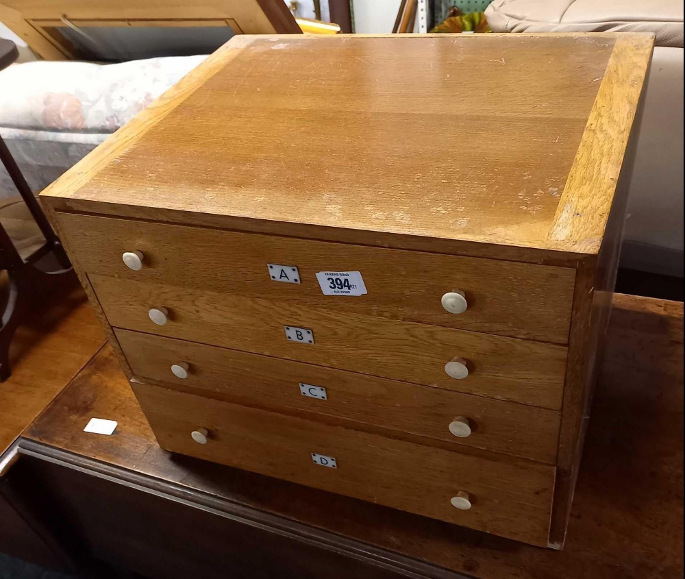 LIGHT OAK CHEST OF 4 DRAWERS (LABELED A, B, C, D) 18'' X 14'' (LABEL ON BACK BAYKO SPARE PARTS)