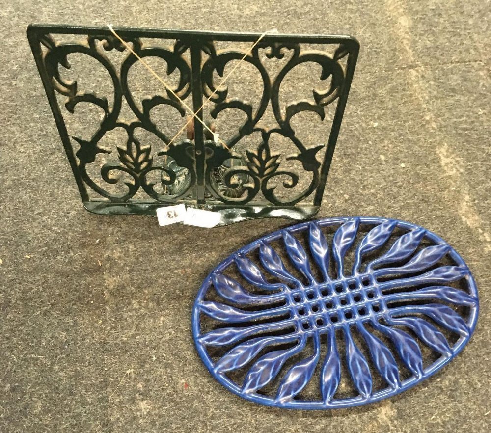 BLUE CAST IRON TRIVET & A GREEN CAST IRON KITCHEN BOOK STAND