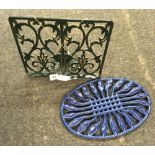 BLUE CAST IRON TRIVET & A GREEN CAST IRON KITCHEN BOOK STAND