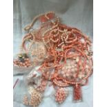 SMALL CARDBOARD BOX OF CORAL BEADS, NECKLACES ETC