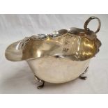 AN OVAL SILVER SAUCE BOAT ON 3 PAD FEET, B'HAM 1931