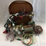 QTY OF COSTUME JEWELLERY, BANGLES, NECKLACES, BROOCHES IN A VICHY JEWELLERY SATCHEL