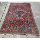 RED PATTERNED WOOLEN CARPET WITH TASSEL ENDS, 92'' X 56'' APPROX