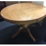 CIRCULAR POLISHED PINE EXTENDING DINING TABLE ON HEAVY PEDESTAL LEGS, 3ft 6'' DIA EXTENDING TO 4ft