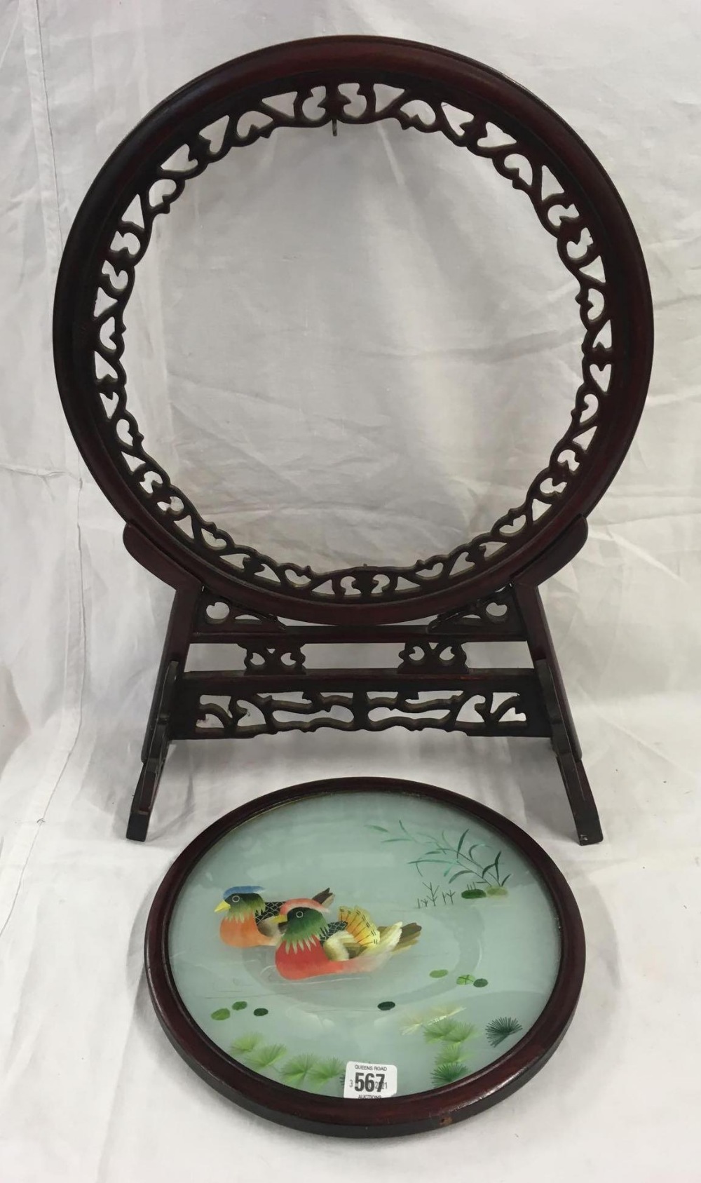 ORIENTAL HARDWOOD CARVED STAND SUPPORTING A CIRCULAR FRAME WITH A MOBILE, DOUBLE-SIDED SILK-WORK