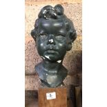 BUST OF A CHILD ON A WOOD BLOCK PLINTH, HEAD RE-ATTACHED A/F