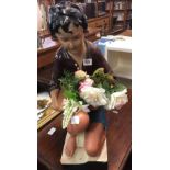 PLASTER FIGURE OF A YOUNG BOY KNEELING WITH FLOWERS