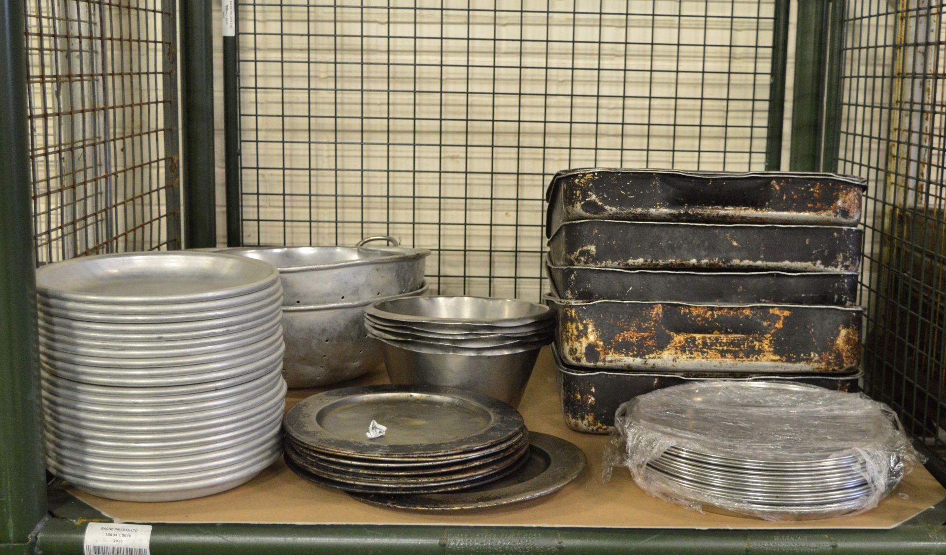 Various cooking trays, metal plates, large sieves