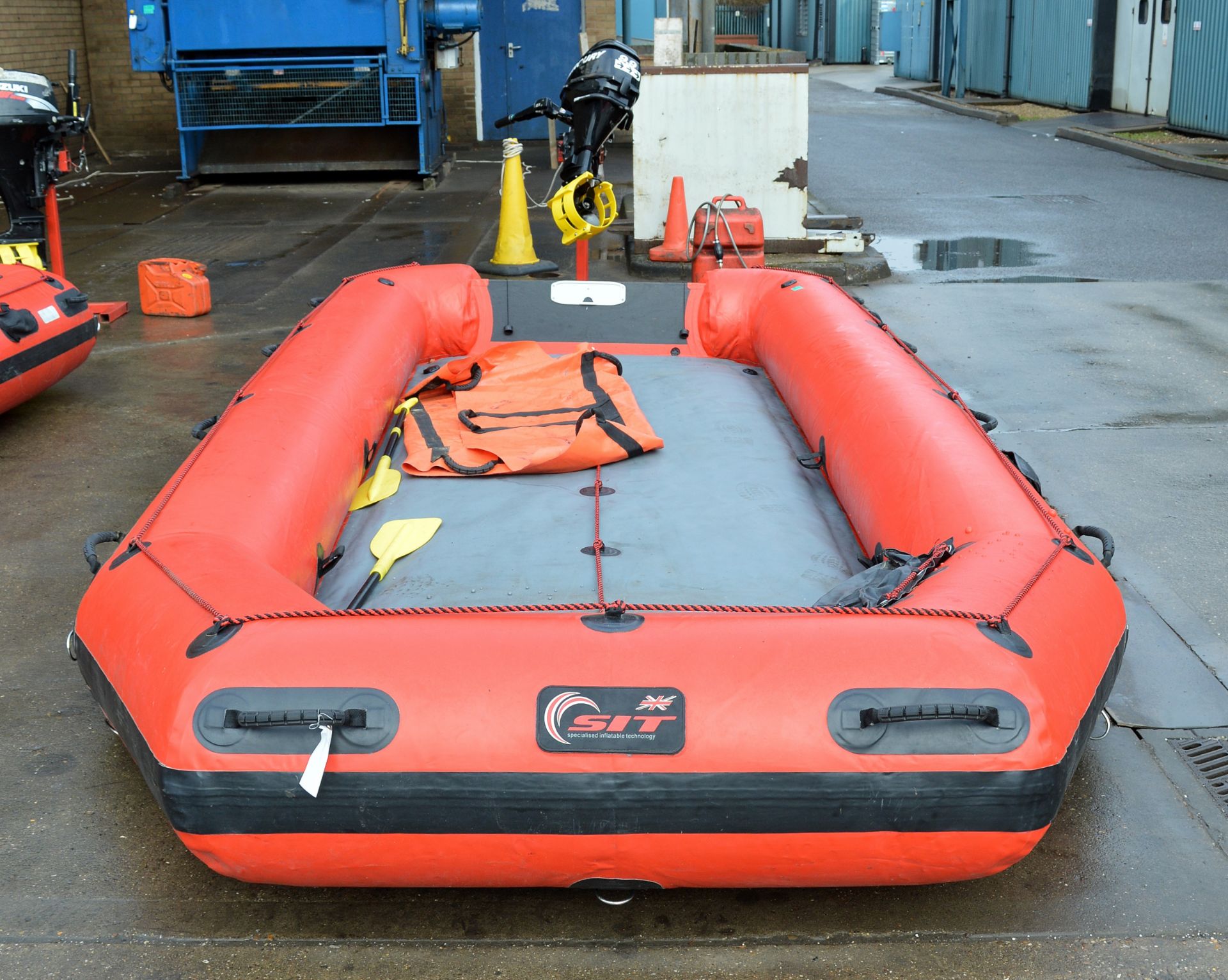 Red inflatable with Mercury 9.9 outboard engine on stand - IF10201FA serial 0R533676, fuel can