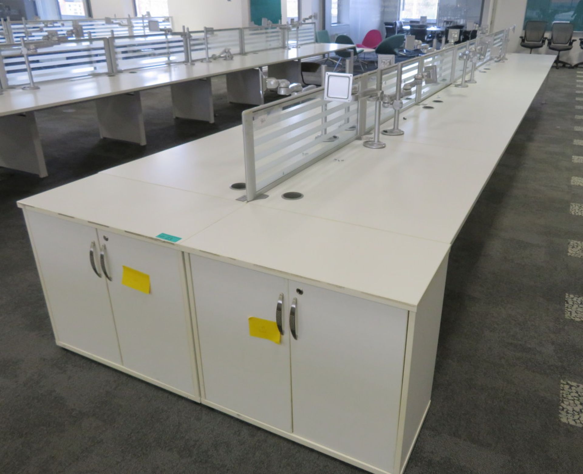 12 Person Desk Arrangement With Dividers, Monitor Arms & Storage Cupboards.