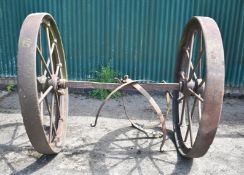 TWO HEAVY DUTY CAST IRON WHEELS WITH AXLE, 52" DIA X 6" WIDE. STEAM ENGINE WATER TANK CARRIER