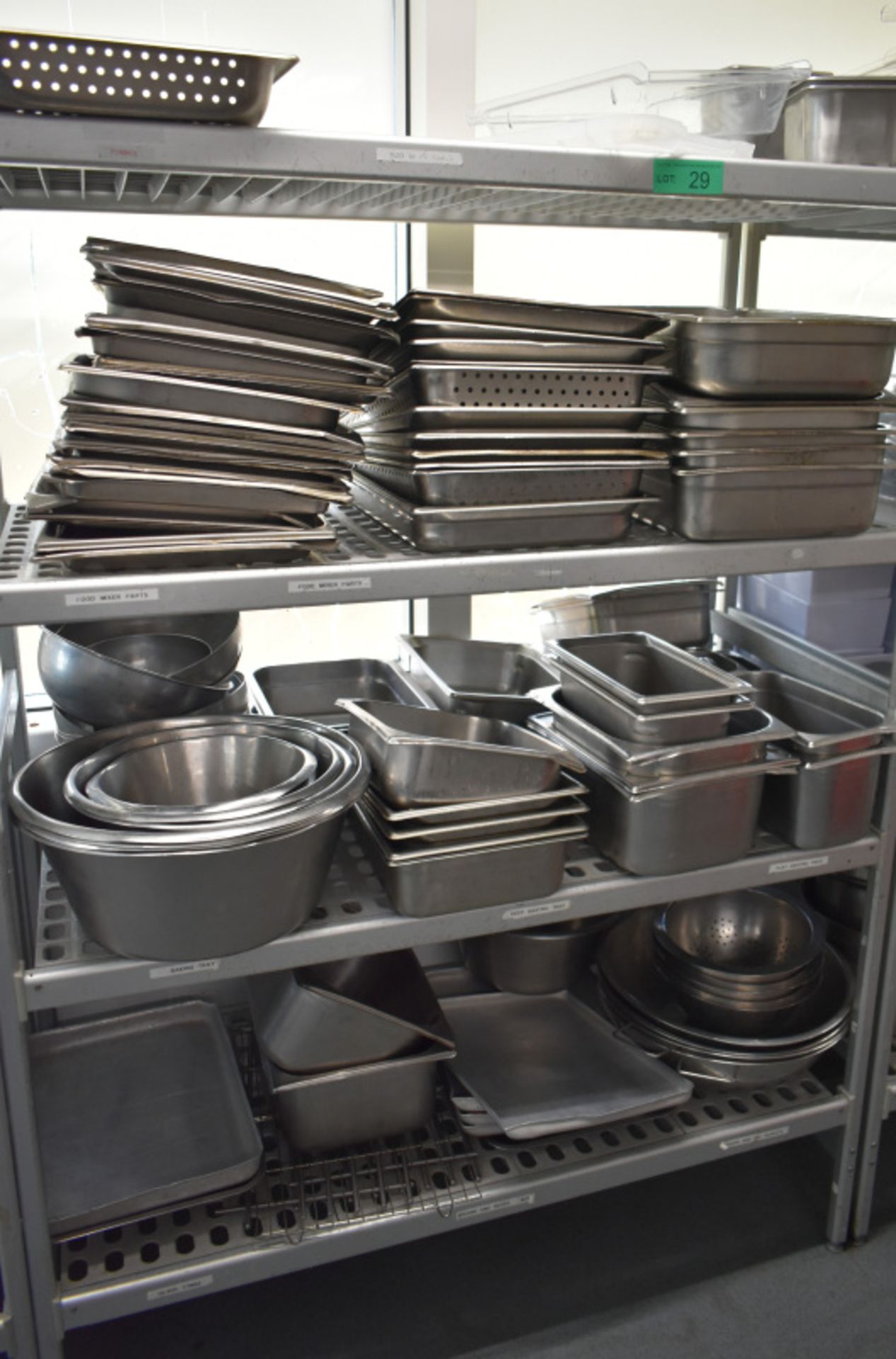 Four tier kitchen storage rack with contents, contents to include- Various stainless steel