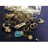 A bag containing a large collection of silver and white metal dress rings, brooches, pendants,