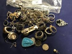 A bag containing a large collection of silver and white metal dress rings, brooches, pendants,